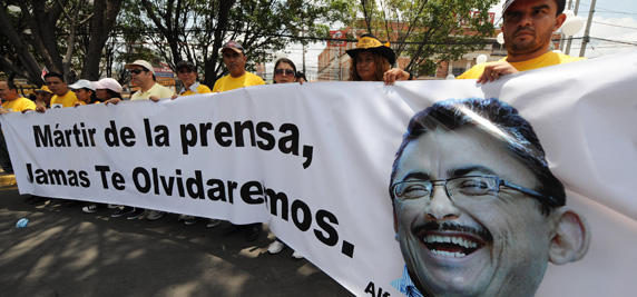 Honduran journalists protest the murder of their colleague, Ángel Alfredo Villatoro. The sign reads, 'Martyr of the press, we will never forget you.' (AFP/Orlando Sierra)