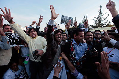 In front of the Parliament building in Islamabad on January 28, journalists demonstrate a spate of recent killings. (Reuters/Faisal Mahmood)