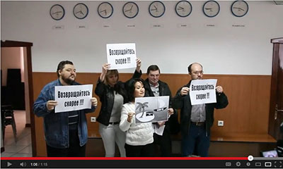 In this YouTube screenshot, supporters of independent media demonstrate at the press conference where owners of Stan.kz announced its shutdown. (YouTube/Respublika Kz)