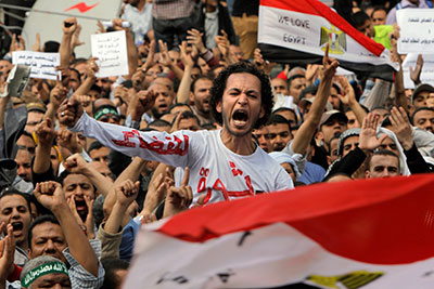 Muslim Brotherhood members shout slogans during a protest in front of the Supreme Judicial Council in Cairo on Friday. Arabic on the T-shirt reads, 'clean judiciary.' (AP/Amr Nabil)