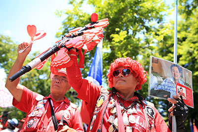 A Red Shirt protester holds a portrait of former Prime Minister Thaksin Shinawatra at a rally in Bangkok on May 8. (Reuters/Athit Perawongmetha)