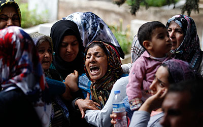 The mother of a victim of a bombing in Reyhanli near the Turkish-Syrian border mourns during her funeral. (Reuters/Umit Bektas)