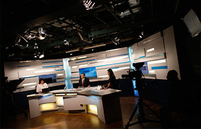 Leopoldo Castillo, center, pauses during his daily broadcast of 'Alo Ciudadano' Tuesday on Globovisión. (Reuters/Jorge Silva)