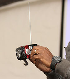 Ndebele demonstrates a hand-cranked radio. (Liesl Frankson/Wits Vuvuzela)