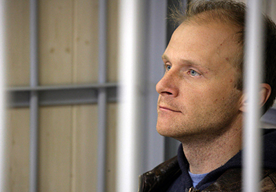 Freelance photographer Denis Sinyakov sits in a defendant cage in court on Thursday. (AFP/Greenpeace/Igor Podgorny)