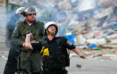 Israeli border police throw tear gas during clashes after a funeral in the Qalandiya refugee camp near the West Bank city of Ramallah on November 29, 2013. (AP/Majdi Mohammed)