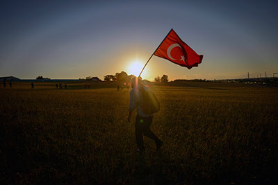 A man holds a flag outside a Turkish jail, where hundreds of people, including journalists, await a verdict in the Ergenekon trial. (AP)