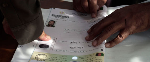 An Afghan man marks his application for voter registration in Kabul, Afghanistan, on September 16, 2013. Journalists' future may hinge on the presidential election scheduled for April 2014. (AP/Rahmat Gul)