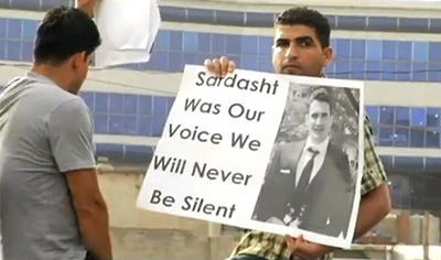 A protester demonstrates against the killing of Sardasht Osman. (YouTube/FilmBrad)