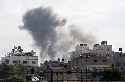 Smoke billows from a Gaza City neighborhood after an Israeli airstrike. (AFP/Mohammed Abed)