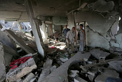 Palestinians search the rubble of their family house which was hit by an Israeli strike in Beit Hanoun, in the northern Gaza Strip. (AP/Adel Hana)