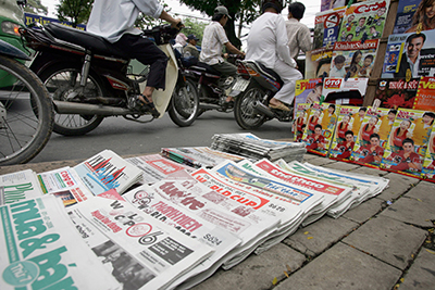 Newspapers are stacked on a Ho Chi Minh City street. The country's state-run press is heavily censored, reporters say. (AFP/Hoang Dinh Nam)