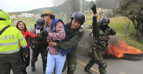 A reporter tries to interview a protester being taken away by police during clashes near Bogotá in 2013. Violence against journalists in Colombia has generally waned, and with it, journalist deaths. (Reuters/Jose Miguel Gomez)