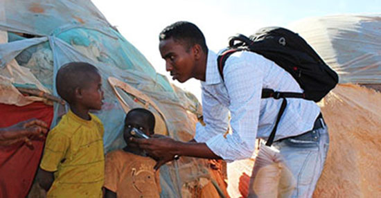 Somali journalist Yusuf Ahmed Abukar, seen here speaking to internally displaced children, was killed by a car bomb in 2014. (Abdukhader Ahmed)