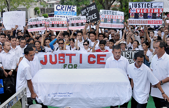 The family, friends, and colleagues of Philippine journalist Daniel Tiamzon march to his funeral. Tiamzon was one of the 32 journalists and media workers killed in the Maguindanao massacre in 2009. (AFP/Jay Directo)