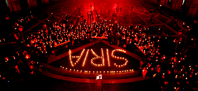 A vigil for victims of the Syrian conflict is held in Rome as the civil war enters its third year. Since 2011, 79 journalists have been killed while covering the war. (AFP/Tiziana Fabi)