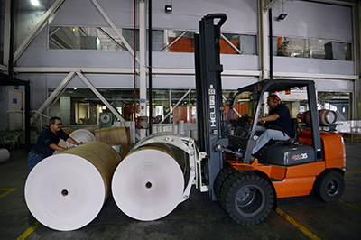 Rolls of donated newsprint are delivered to papers in Caracas. The country's press is struggling to have supplies imported. The shortage has forced the daily Correo del Caroní to cut its page numbers. (AFP/Juan Barreto)