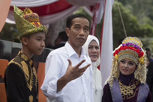 President Joko Widodo, pictured second left in Aceh province in March. Before he was elected in 2014, Widodo said he would allow international journalists access to Papua. (AFP/Chaideer Mahyuddin)