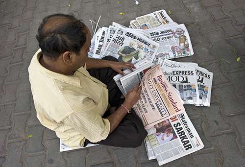 Indian papers announce the election victory of Narendra Modi in May 2014. Journalists say reporting on government issues has become challenging in the past year. (AFP/Prakash Singh)