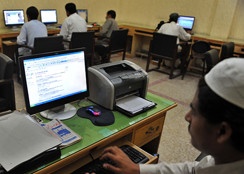 Journalists browse the Internet in Peshawar. Pakistan's draft cybercrime bill includes a section seeking to justify government censorship of Web content. (AFP/A Majeed)