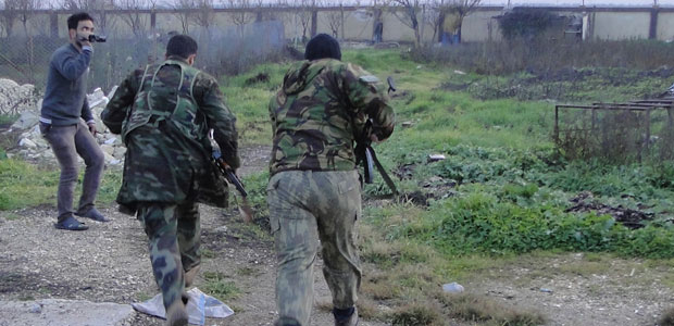 Free Syrian Army fighters are filmed as they run towards the fence of the Menagh military airport, trying to avoid snipers loyal to Syria's President Bashar al-Assad in Aleppo's countryside on January 6, 2013. (Reuters/Mahmoud Hassano)