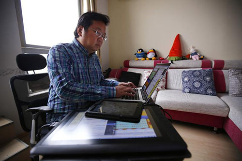 Wang Liming, pictured in 2013, says he fears he will be arrested if he returns to China. The political cartoonist is living in Japan but says he is running out of funds. (Reuters/Petar Kujundzic)