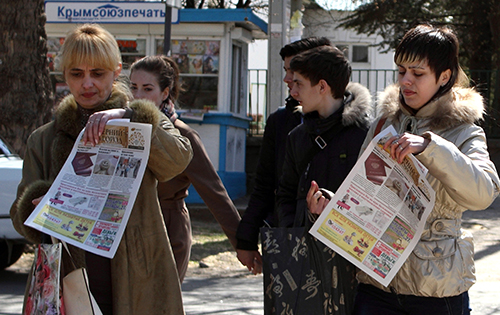 Newspapers showing a Russian passport are sold in Simferopol. Crimeans were given a month to officially state that they wanted to retain Ukrainian citizenship. (AFP/Yuriy Lashov)