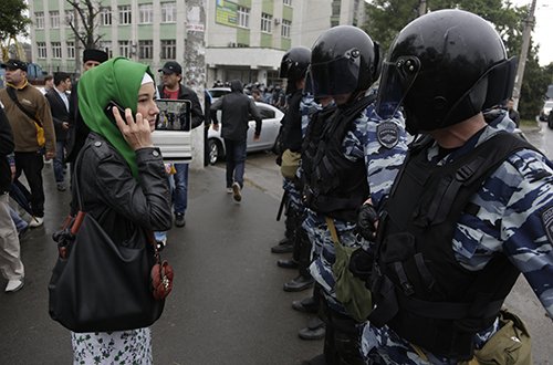 Russian riot police block a road in Simferopol as Crimean Tatars gather for a rally. The ethnic minority's main broadcaster has been forced off air since annexation. (AP/Max Vetrov)