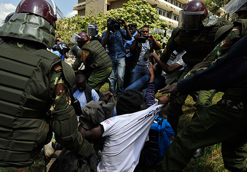 Police arrest a protester at a rally against proposed security laws which threaten fines and jail over reports deemed to ‘undermine terror investigations.’ (AFP/Simon Maina)