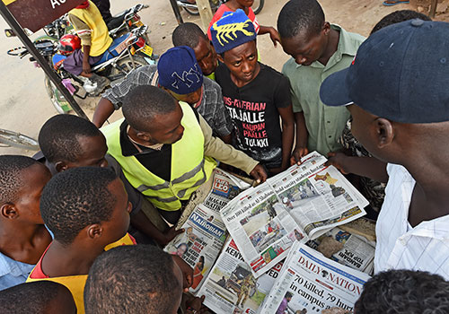 Local papers report on the Garissa college massacre in April. Under proposed media laws, journalists may face fines for showing victims of attacks without police permission. (AFP/Carl de Souza)