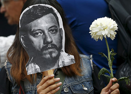 A protester holds up a photograph of Rubén Espinosa, who was killed after he fled Veracruz state. Mexico is one of the most dangerous countries for journalists. (Reuters/Henry Romero)