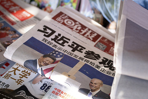 Newspapers in Beijing report on the president's visit to the U.S. News of protests in th U.S. about China's human rights record are absent from China's press. (AP Photo/Mark Schiefelbein)