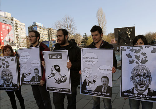 Cartoons of Turkey’s attempt to silence critics by blocking Twitter are held up by protesters. Turkey will need to improve its press freedom record before being admitted into the EU. (AP/Burnhan Ozbilici)