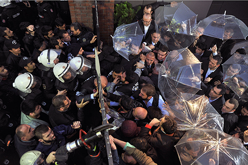 Riot police force their way into the headquarters of an opposition news outlet on October 28 as Turkey forces the Koza İpek Group to replace senior managers with a government-approved board of trustees. (AP/Usame Ari, Cihan News Agency)