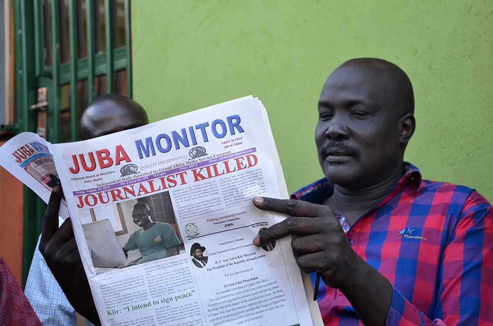 South Sudan newspaper Juba Monitor reports on the murder of Peter Julius Moi, who was shot dead in August. A series of journalist killings have put the newly independent country on the Impunity Index.  (AFP/Samir Bol)