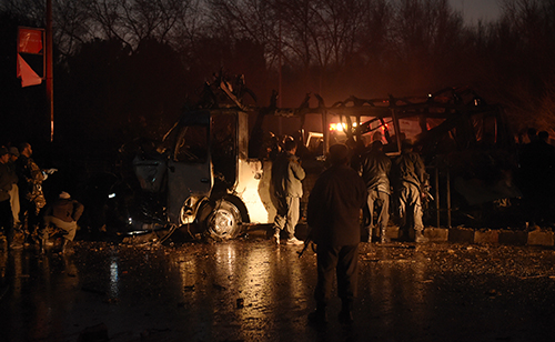 Afghan security forces examine the wreckage of a vehicle carrying Tolo TV employees in Kabul. A suicide attack on the minivan killed six staff and injured more than 25. (AFP/Shah Marai)