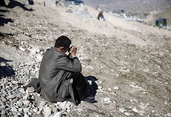 The brother of a Tolo TV employee killed in a suicide attack on Kabul television station weeps at his funeral, January 26, 2016 (Reuters/Ahmad Masood).