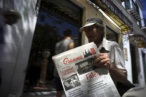 Copies of the state-run newspaper Granma are sold on the streets on Havana. Cuba does not allow privately owned media outlets but bloggers say they are increasingly able to report independently. (AP/Ramon Espinosa)