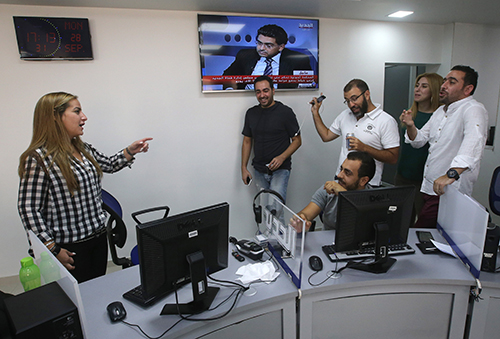 Karma Khayat, pictured left in Al-Jadeed's newsroom. A conviction against her by the Special Tribunal of Lebanon has been overturned. (AP/Hussein Malla)
