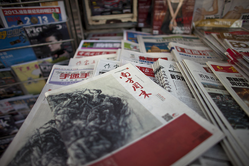 Copies of the altered 2013 edition of Southern Weekly. Weibo posts about protests over the changed editorial were censored. (AP Photo/Alexander F. Yuan)