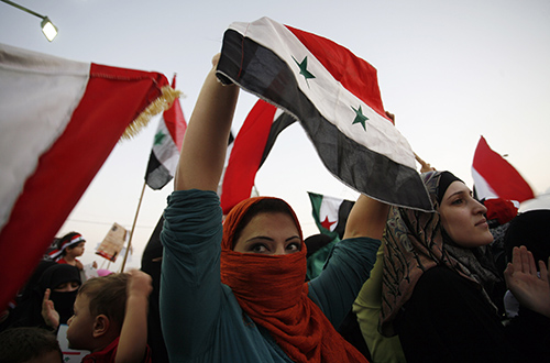 Syrians protest the killing and torture of women by President Assad's regime in 2011. The blogger Tal al-Mallohi remains in jail in Syria despite a court ordering her release. (AP/Mohammad Hannon)