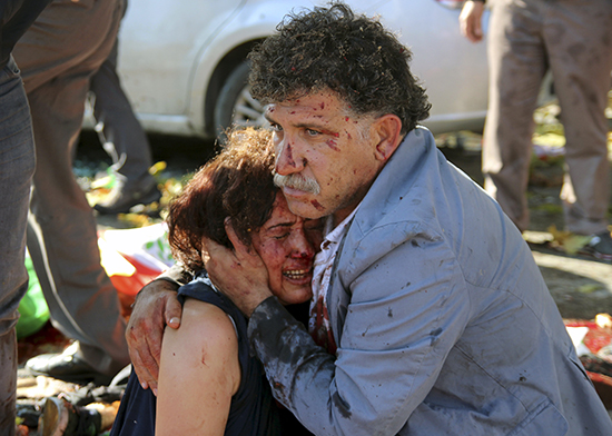 A man and woman embrace after a bomb exploded in Ankara, October 15, 2015 (Reuters).