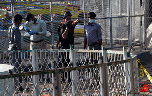 Forensics experts investigate the site of the Lahore suicide bombing. The Pakistani Taliban claimed responsibility and warned the media could be next. (AFP/Arif Ali)