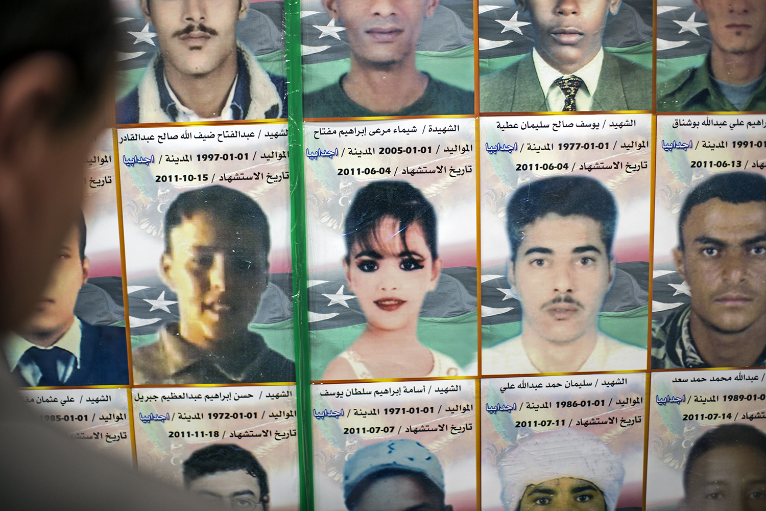 Images of Libyans who were killed during the 2011 siege of Misrata in the city's war museum. Women journalists have become acutely aware of their visibility since the uprising. (Iason Athanasiadis)