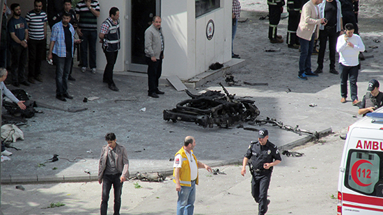 Security officials investigate the scene of a bombing in front of a police station in Gaziantep, Turkey, May 1, 2016. Police detained Mehmet Hakkı Yılmaz, the first reporter at the scene, after he filed his story, his employer said. (IHA/AP)