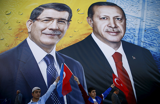 Supporters of the ruling Justice and Development Party (AKP) wave flags in front of a mural of Turkish President Recep Tayyip Erdoğan and Prime Minister Ahmet Davutoglu (left) at an election rally in Konya, Turkey, October 30, 2015. (Umit Bektas/Reuters)