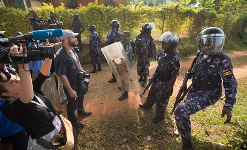 In this February 22, 2016, photo, riot police prevent the media from approaching Uganda's main opposition leader Kizza Besigye as he tries to leave his house in Kasangati, Uganda. (AP/Ben Curtis)