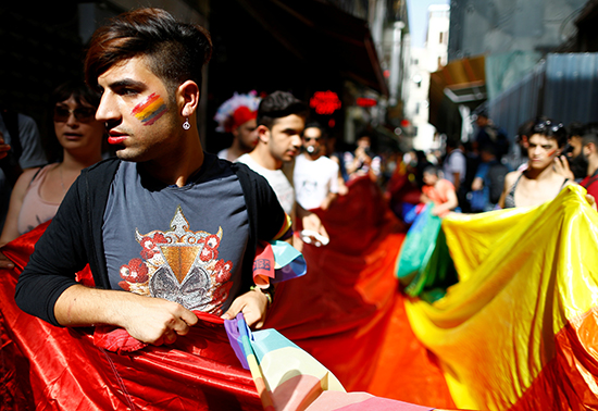 Activists hold a rainbow flag at a banned "Trans Pride" rally in central Istanbul, June 19, 2016. Police used tear gas and water cannons to disperse marchers and detained journalists trying to cover the event, according to press accounts. (Osman Orsal/Reuters)