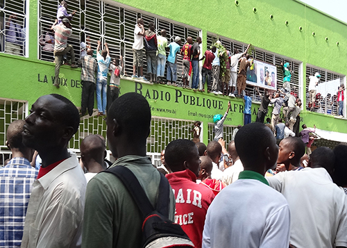 Burundians gather outside Radio Publique Africaine to celebrate the release from jail of radio director Bob Rugurika in February 2015. Rugurika says he received threats after being freed and was forced into hiding. (AFP/Esdras Ndikumana)