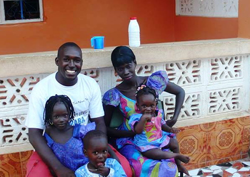 Sanna Camara, pictured with his wife and children. The reporter says when he calls home, his daughter asks when he is coming home. (Sanna Camara)